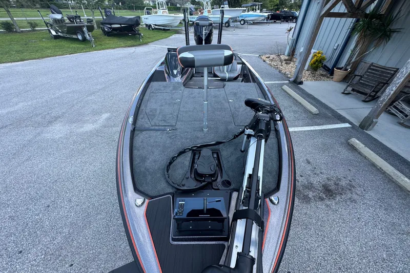 Slide: The Image of 2026 Skeeter ZXE20 boat with trolling motor in a parking area. - 9
