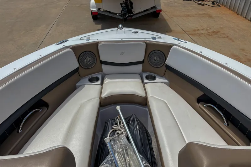 Slide: The Image of 2016 Four Winns H210 boat interior with beige seating and cup holders. - 5