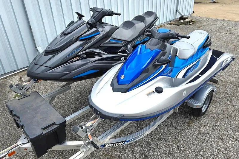 The Image of Two 2020 Yamaha WaveRunner jet skis on a trailer, parked outdoors. - 0