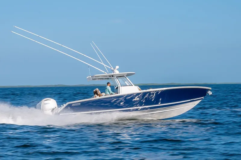 The Image of 2026 Jupiter 340LS boat cruising on open water, featuring sleek design and powerful engines. - 0