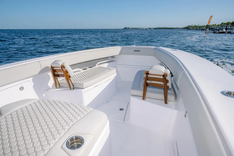 Slide: The Image of Luxurious 2026 Jupiter 340LS boat interior with elegant seating on open water. - 11