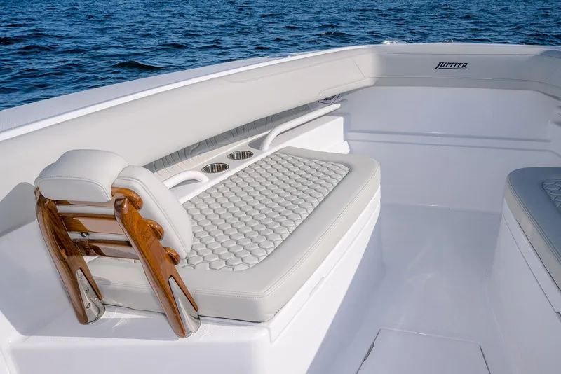 Slide: The Image of Luxurious seating on 2026 Jupiter 340LS boat with elegant design and ocean backdrop. - 12