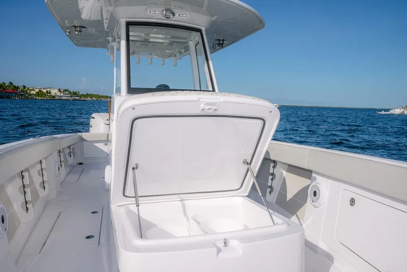 Slide: The Image of 2026 Jupiter 340LS boat with open storage compartment on a sunny day at sea. - 16
