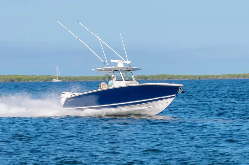 Slide: The Image of 2026 Jupiter 340LS boat cruising on open water under clear blue skies. - 2