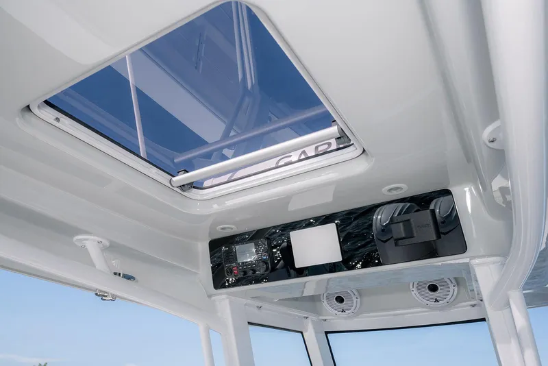 Slide: The Image of Interior view of 2026 Jupiter 340LS boat, featuring a skylight and control panel. - 24