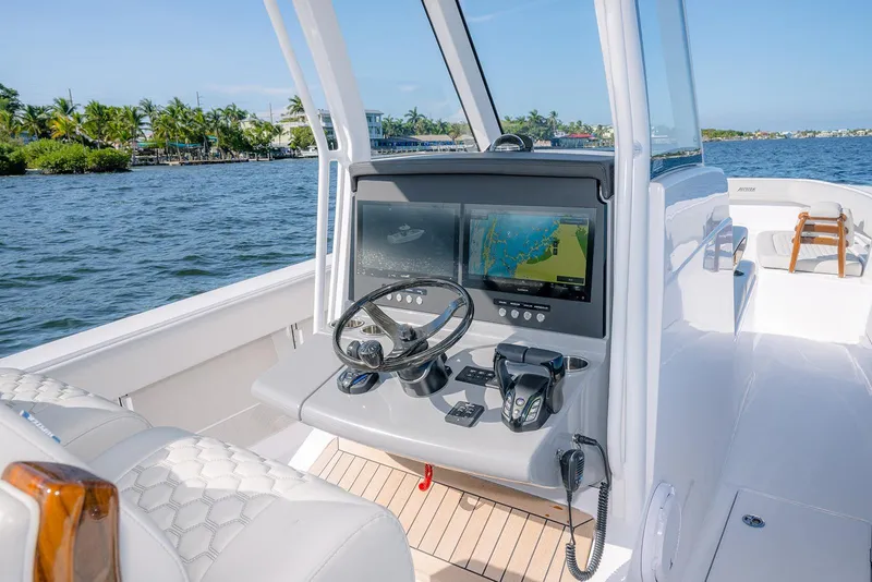 Slide: The Image of 2026 Jupiter 340LS boat cockpit with modern navigation system on a sunny day. - 30