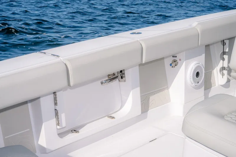 Slide: The Image of 2026 Jupiter 340LS boat interior with white seating and ocean backdrop. - 36