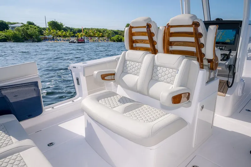 Slide: The Image of 2026 Jupiter 340LS boat interior with luxurious seating and modern dashboard on a sunny day. - 37