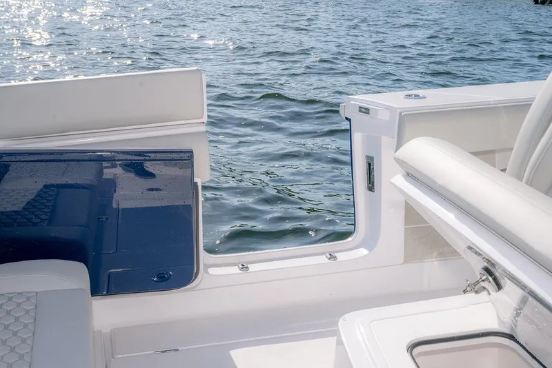 Slide: The Image of 2026 Jupiter 340LS boat interior with open side door, overlooking sparkling water. - 40