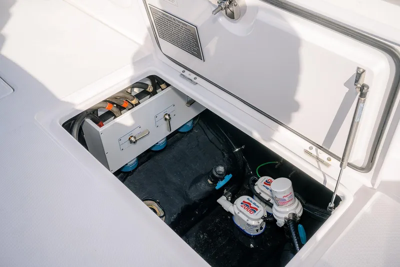Slide: The Image of Jupiter 340LS 2026 boat compartment with pumps and wiring. - 41