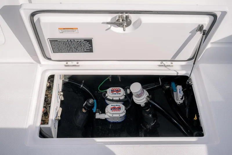 Slide: The Image of 2026 Jupiter 340LS boat compartment with pumps and wiring, open hatch view. - 42
