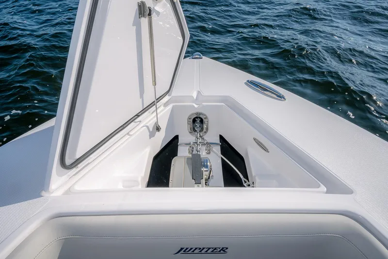 Slide: The Image of 2026 Jupiter 340LS boat anchor compartment open on calm water. - 9