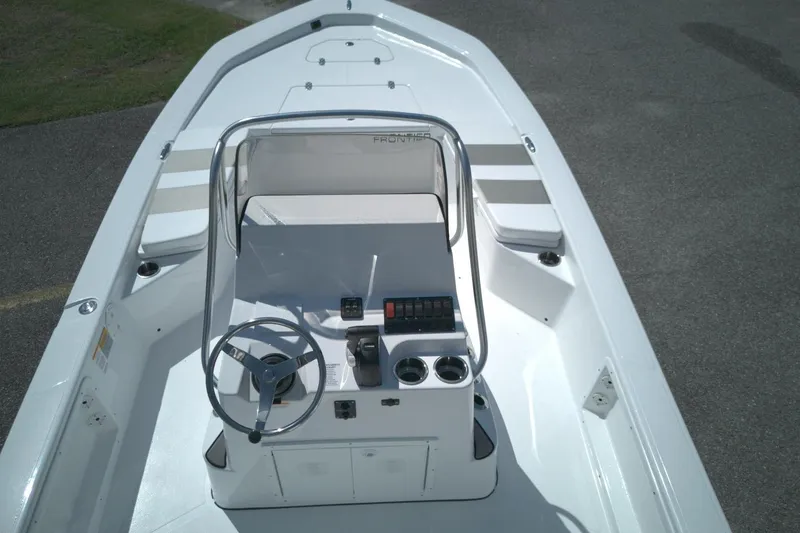 Slide: The Image of 2026 Frontier 2104 boat interior with steering console and seating, viewed from above. - 6