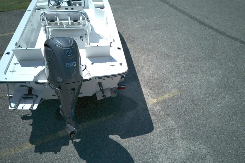 Slide: The Image of 2026 K2 Marine 2104 Frontier boat with Yamaha 200 outboard motor, parked on asphalt. - 8