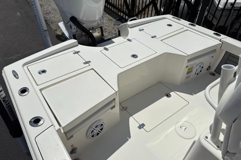 Slide: The Image of 2024 Pathfinder 2500 Hybrid boat deck with storage compartments and engine view. - 14