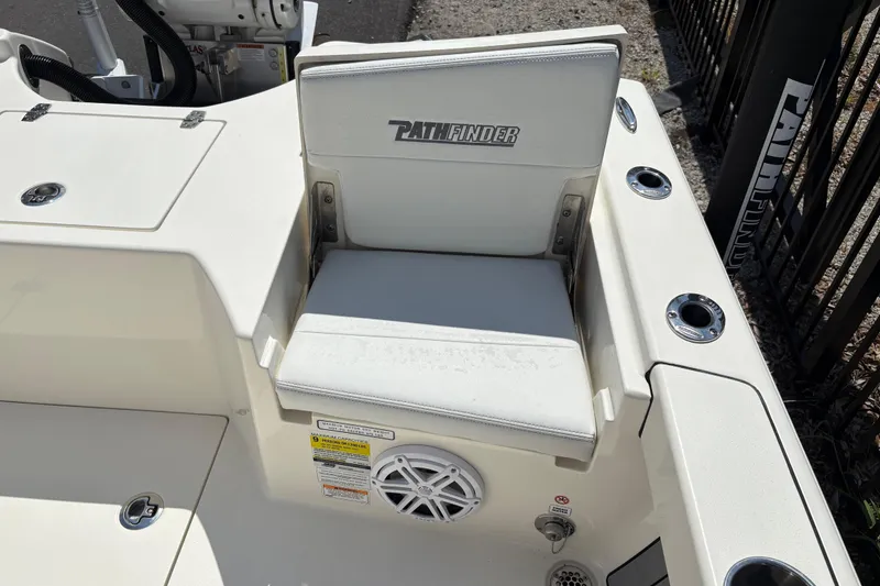 Slide: The Image of 2024 Pathfinder 2500 Hybrid boat seat with logo, cup holders, and speaker. - 15