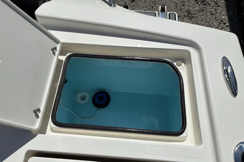 Slide: The Image of Open storage compartment on 2024 Pathfinder 2500 Hybrid boat, featuring a blue interior. - 18