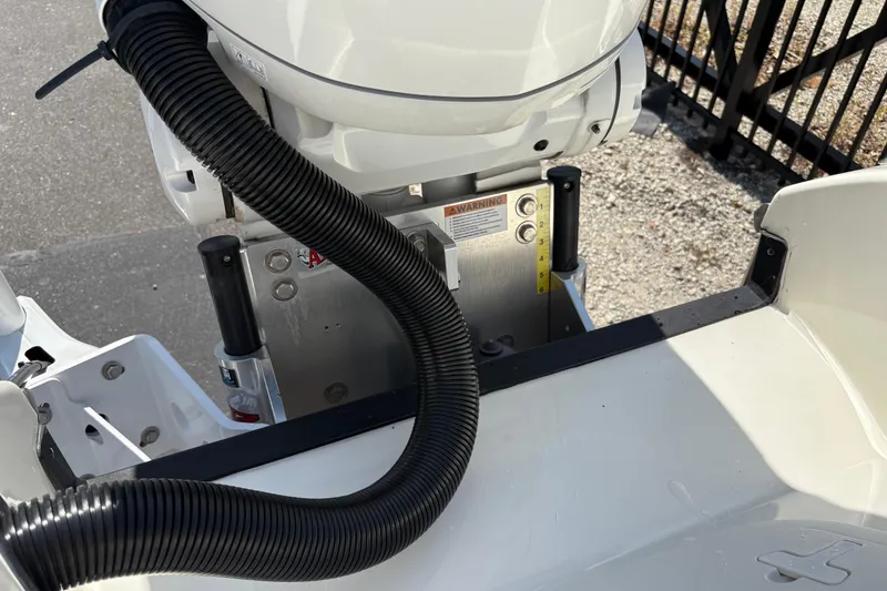 Slide: The Image of 2024 Pathfinder 2500 Hybrid boat engine detail with hydraulic components and warning label. - 20