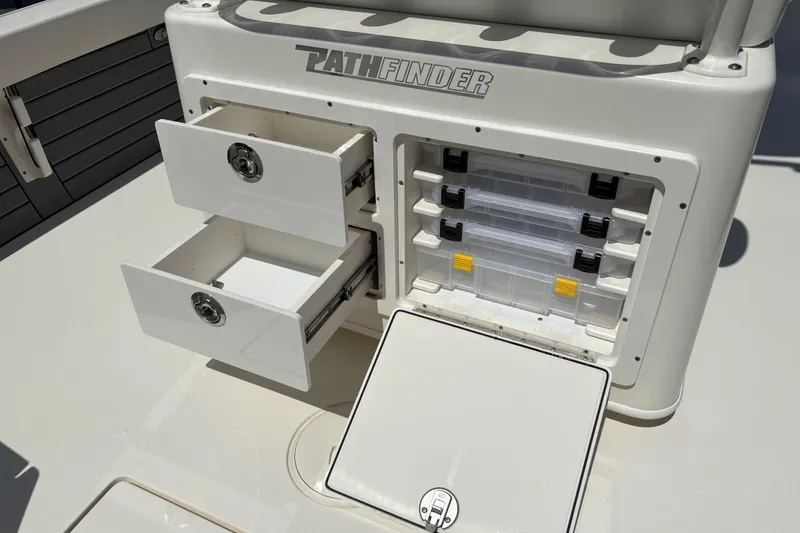 Slide: The Image of 2024 Pathfinder 2500 Hybrid boat storage compartments with drawers and tackle boxes. - 23