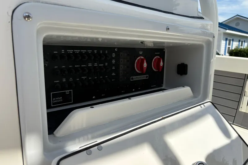 Slide: The Image of 2024 Pathfinder 2500 Hybrid boat control panel with switches and circuit breakers. - 27