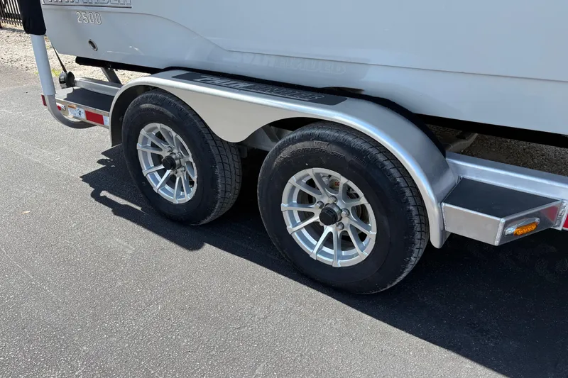 Slide: The Image of 2024 Pathfinder 2500 Hybrid trailer with dual wheels on asphalt surface. - 29
