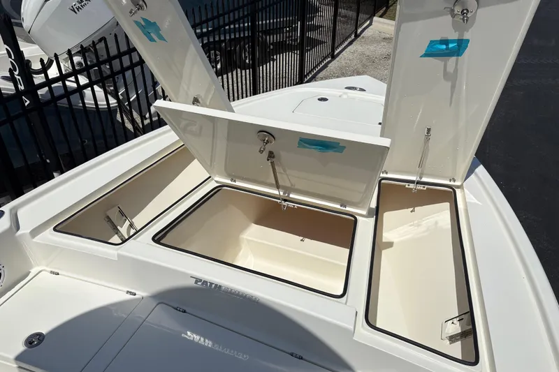 Slide: The Image of 2024 Pathfinder 2500 Hybrid boat storage compartments open, showcasing spacious interior design. - 6