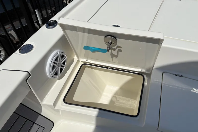 Slide: The Image of 2024 Pathfinder 2500 Hybrid boat with open storage compartment and speaker. - 8