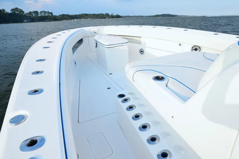 Slide: The Image of 2024 SeaVee 420Z boat deck with seating, rod holders, and ocean view. - 13