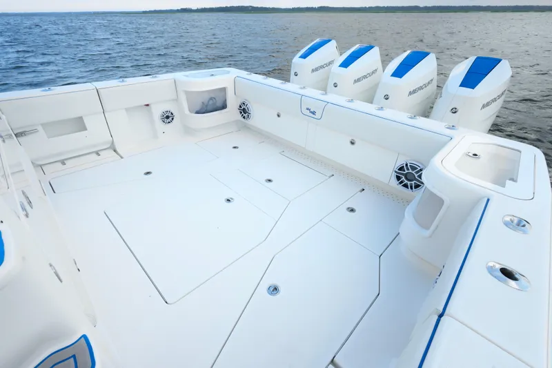 Slide: The Image of 2024 SeaVee 420Z boat deck with four Mercury outboard engines on open water. - 14