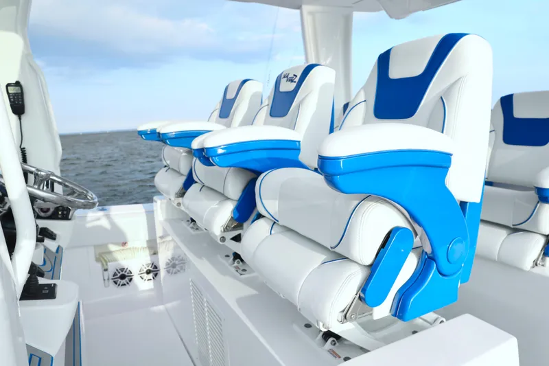 Slide: The Image of 2024 SeaVee 420Z boat interior with blue and white seating, ocean view. - 15