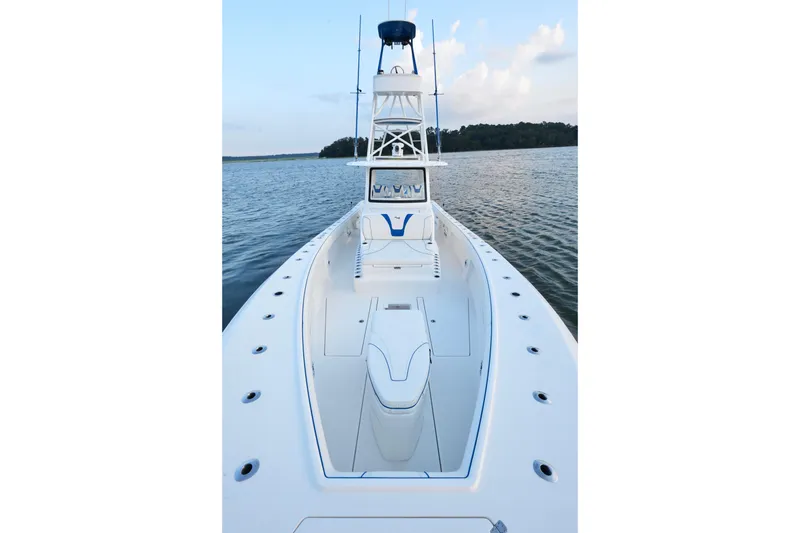 Slide: The Image of 2024 SeaVee 420Z boat on calm water, showcasing sleek design and spacious deck. - 18