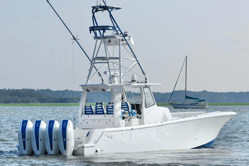 Slide: The Image of 2024 SeaVee 420Z boat with four engines on calm water, featuring a sleek design. - 5