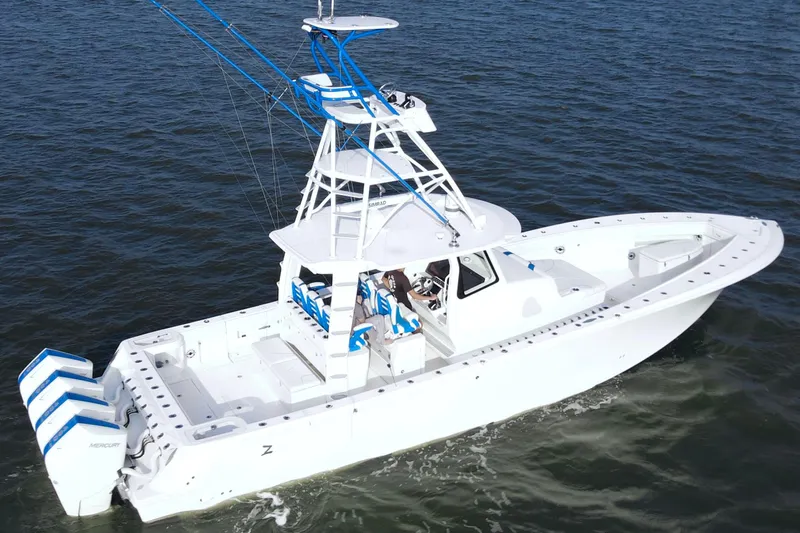 Slide: The Image of 2024 SeaVee 420Z boat cruising on open water, featuring multiple outboard engines. - 6