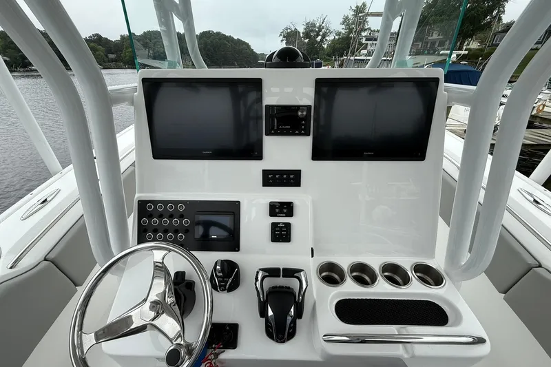 Slide: The Image of 2022 Cape Horn 34 XS boat console with dual screens and steering wheel. - 20