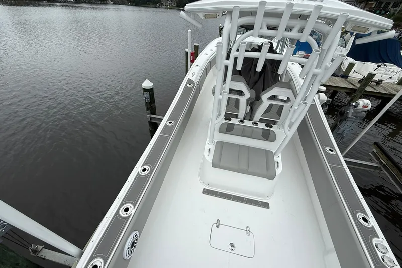Slide: The Image of 2022 Cape Horn 34 XS boat interior with seating and rod holders, docked by the water. - 25