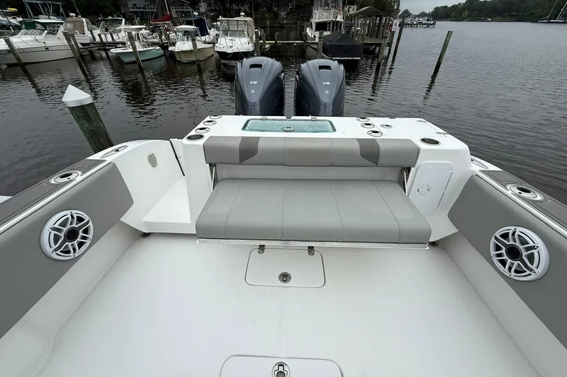Slide: The Image of 2022 Cape Horn 34 XS boat interior with seating and dual engines at a marina. - 29