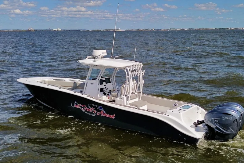 Slide: The Image of 2022 Cape Horn 34 XS boat cruising on open water under a clear blue sky. - 30