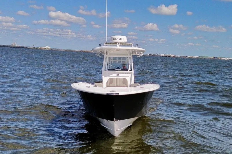 Slide: The Image of 2022 Cape Horn 34 XS boat on open water under a clear blue sky. - 36