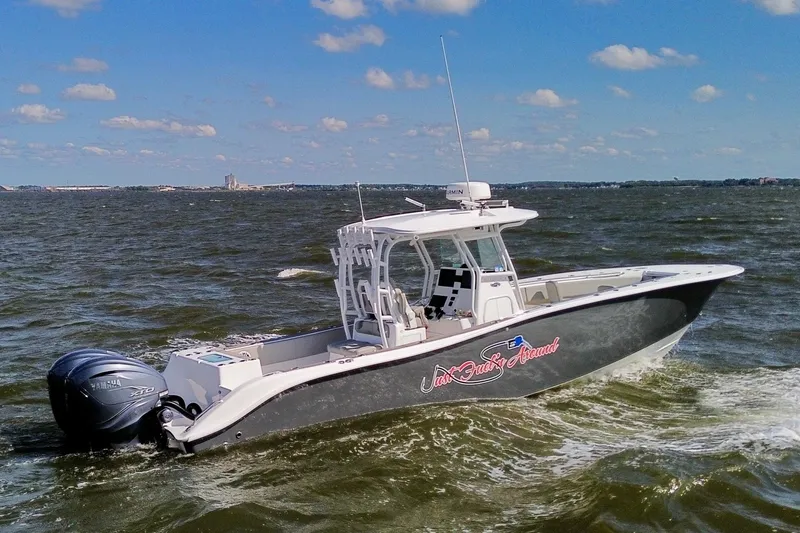 Slide: The Image of 2022 Cape Horn 34 XS boat cruising on open water under a clear sky. - 4