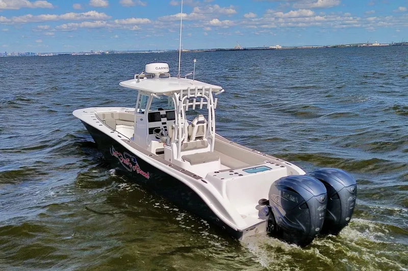 Slide: The Image of 2022 Cape Horn 34 XS boat cruising on open water under a clear sky. - 5