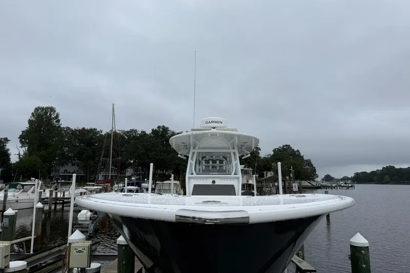 Slide: The Image of 2022 Cape Horn 34 XS boat docked at a marina on a cloudy day. - 9