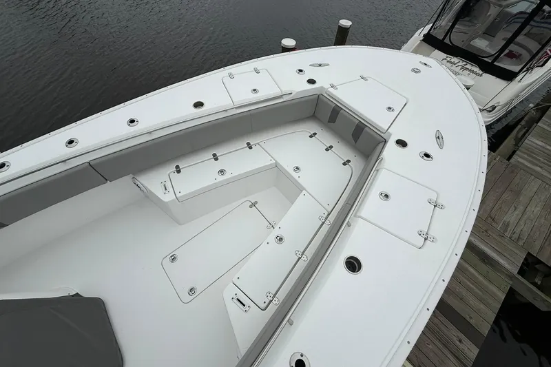 Slide: The Image of 2022 Cape Horn 34 XS boat with spacious deck and storage compartments at dock. - 12
