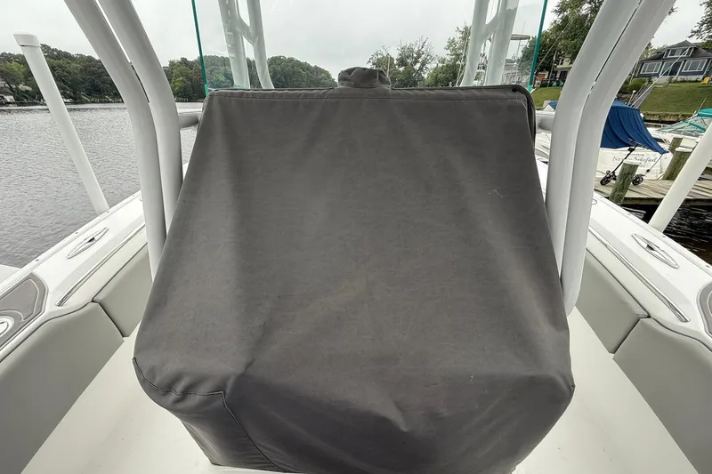 Slide: The Image of 2022 Cape Horn 34 XS boat console covered, docked by a serene waterfront. - 19