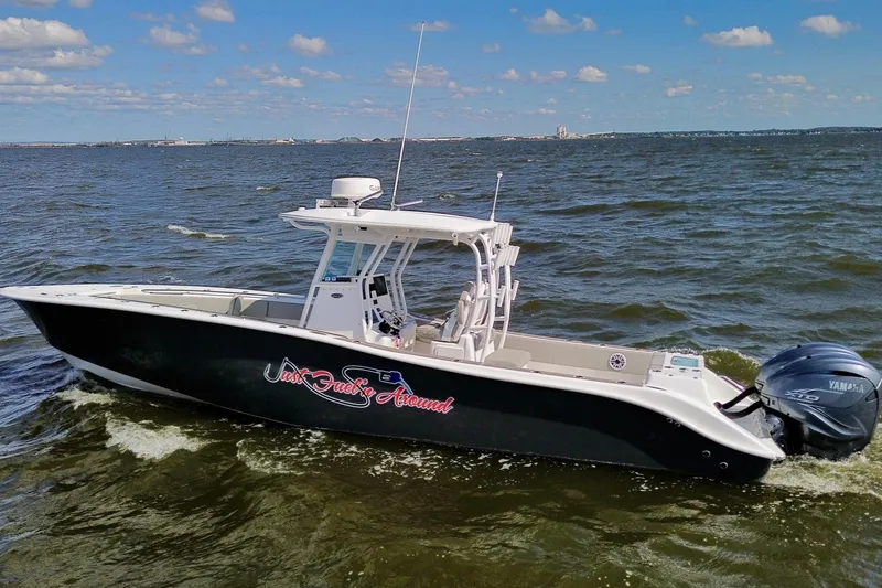 Slide: The Image of 2022 Cape Horn 34 XS boat cruising on open water under a clear blue sky. - 2