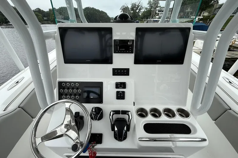 Slide: The Image of 2022 Cape Horn 34 XS boat dashboard with dual screens and steering wheel. - 21