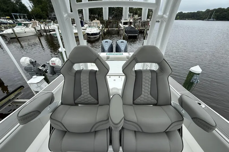 Slide: The Image of 2022 Cape Horn 34 XS boat interior with dual gray captain seats at marina. - 22