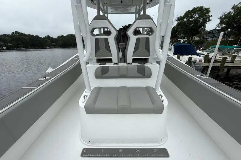 Slide: The Image of 2022 Cape Horn 34 XS boat interior with gray seating and waterfront view. - 23