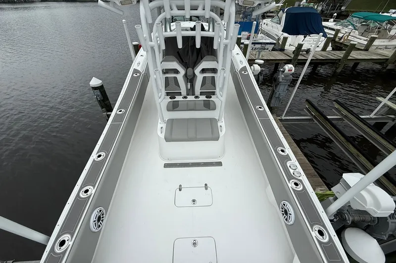 Slide: The Image of 2022 Cape Horn 34 XS boat docked, showcasing spacious deck and seating area. - 26