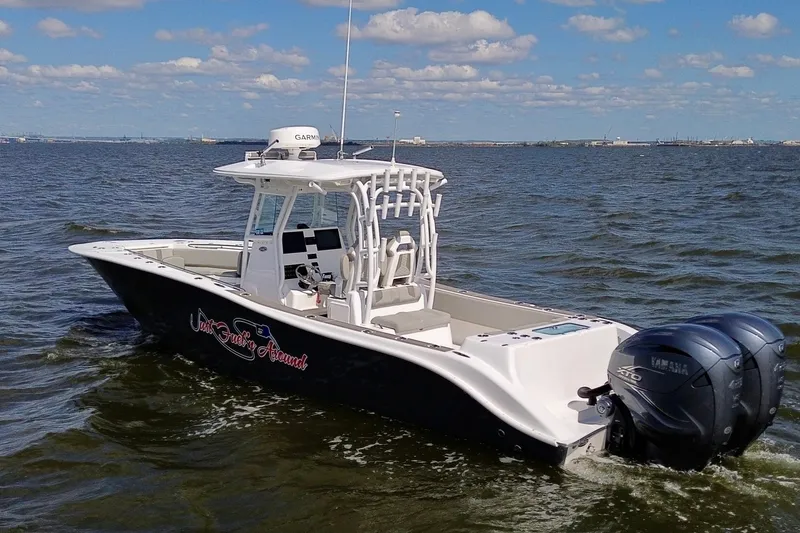Slide: The Image of 2022 Cape Horn 34 XS boat on open water with twin Yamaha engines. - 3