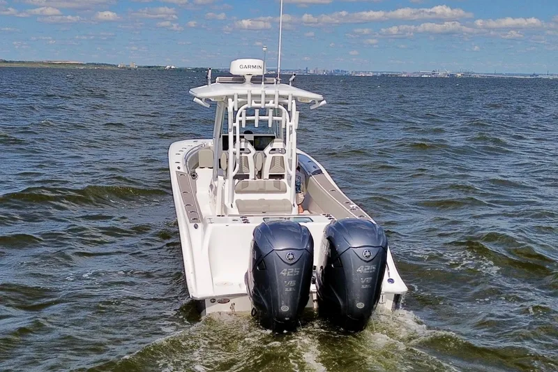 Slide: The Image of 2022 Cape Horn 34 XS boat with dual engines cruising on open water. - 32